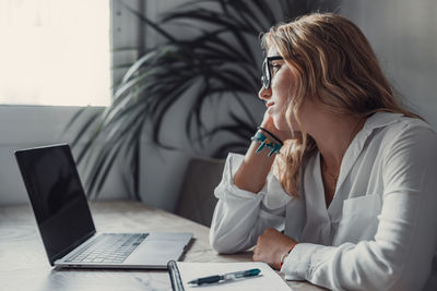 Young woman using laptop at office