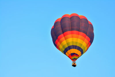 Low angle view of hot air balloon against blue sky