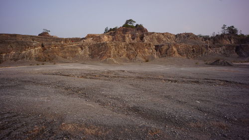 Rock formations on landscape against sky