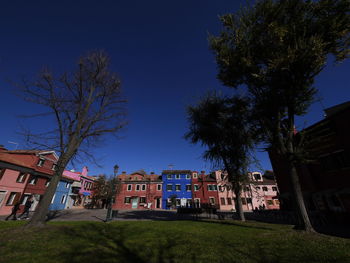 Low angle view of buildings against blue sky