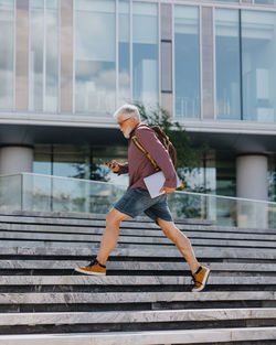 Full length of woman walking on steps