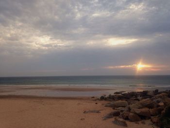 Scenic view of beach against sky during sunset