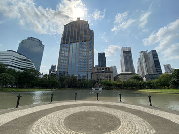 Buildings in city against cloudy sky