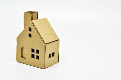 Close-up of cardboard model house over white background