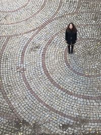 High angle view of woman walking on footpath