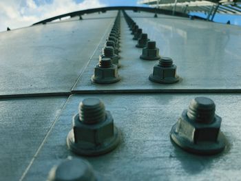 High angle view of metal water tank , rows of metal nuts and bolts