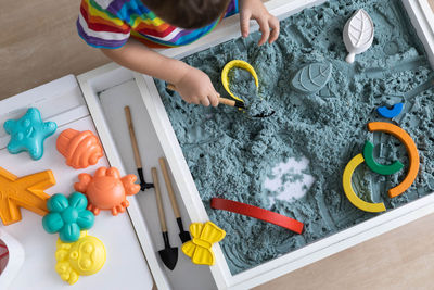 High angle view of girl playing with toy