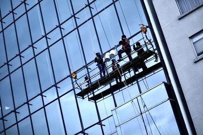 Low angle view of people working at construction site