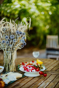 Close-up of brekfast and flowers on table