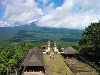 Scenic view of building and mountains against sky