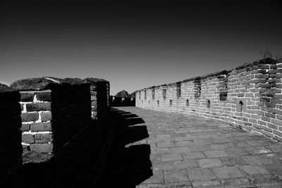 Cobblestone street against clear sky