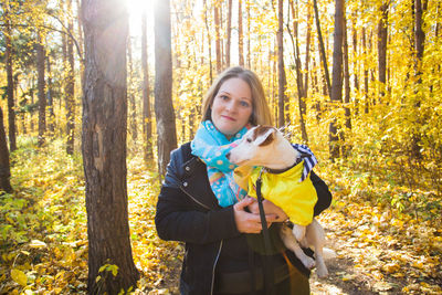 Portrait of young woman in forest during autumn