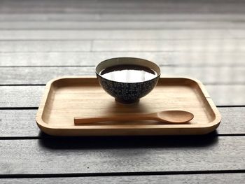 Close-up of tea cup in wooden tray on table