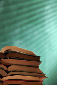 Close-up of books on table against wall