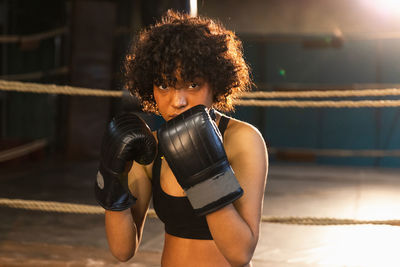 Portrait of young woman exercising in gym