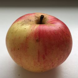 Close-up of red apple on white background