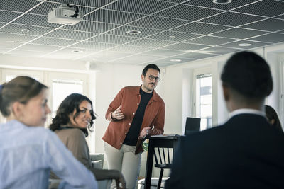 Group of business people attending presentation during conference