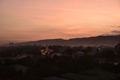 Silhouette buildings against sky during sunset