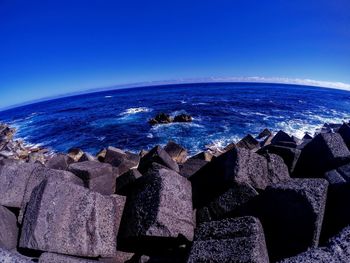 Scenic view of sea against clear blue sky