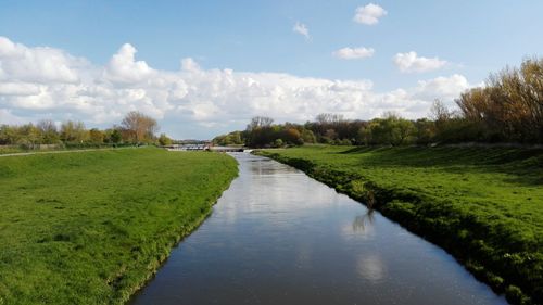 View of canal along trees in park