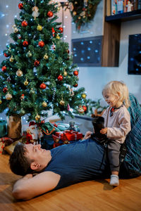 High angle view of mother and daughter sitting at home