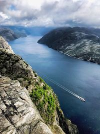 High angle view of sea and mountains against sky