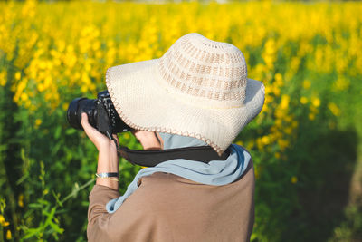 Midsection of woman wearing hat
