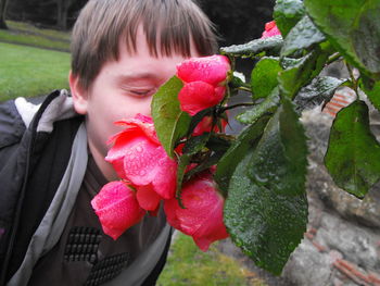 Close-up of young woman with red leaves