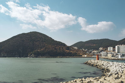 Scenic view of sea and buildings against sky