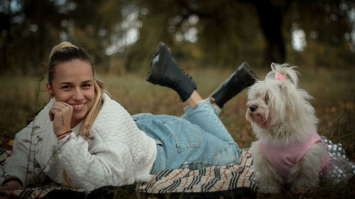 Side view of young man with dog in park