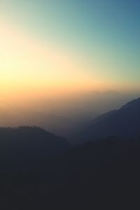 Scenic view of mountains against sky at sunset