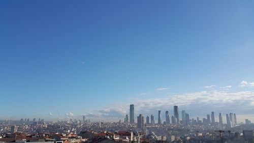 View of cityscape against blue sky