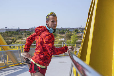Runner warming up on a yellow bridge outdoors person