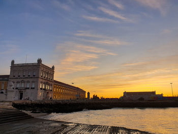 Buildings in city at sunset