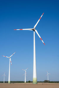 Modern wind turbines seen in rural germany