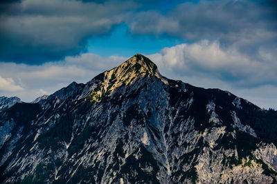 Low angle view of snowcapped mountains against sky