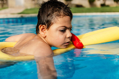 Boy swimming in pool