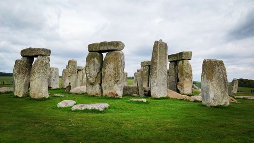 View of old ruins on field against sky