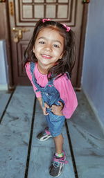 Portrait of smiling girl standing outdoors