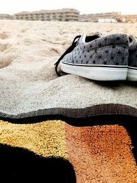 Close-up of shoes on sand