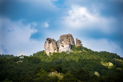 Low angle view of rock formation against sky