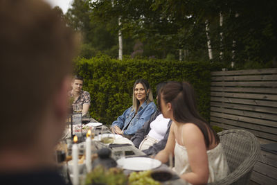 Friends having meal in garden