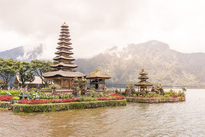 Traditional building against sky with mountain in background