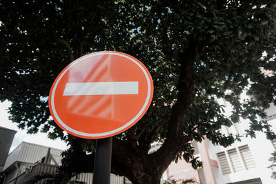 Low angle view of road sign against trees