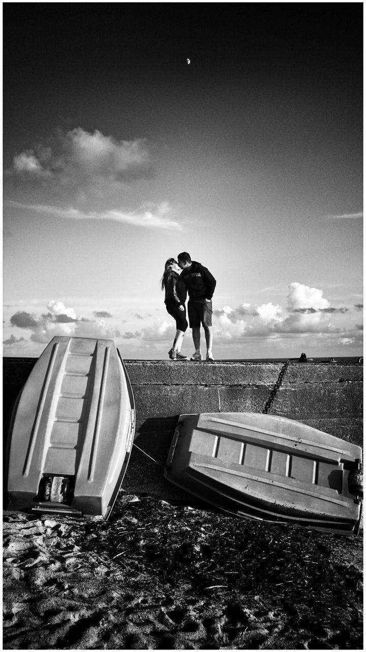 sky, transfer print, sea, men, horizon over water, auto post production filter, lifestyles, rear view, leisure activity, silhouette, transportation, water, cloud, full length, standing, cloud - sky, day, person