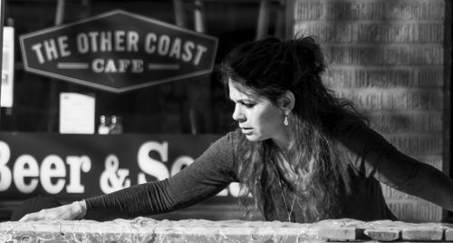 Portrait of young woman with text on table