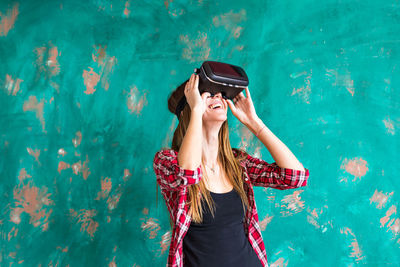 Woman standing outdoors wearing virtual reality headset