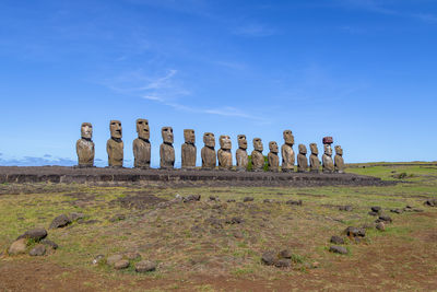 Wooden posts on field against sky