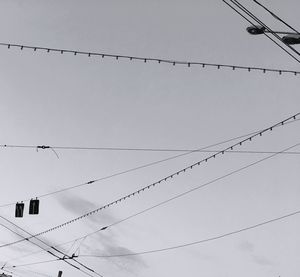 Low angle view of cables against sky