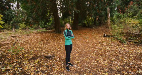 Portrait of young woman standing in forest